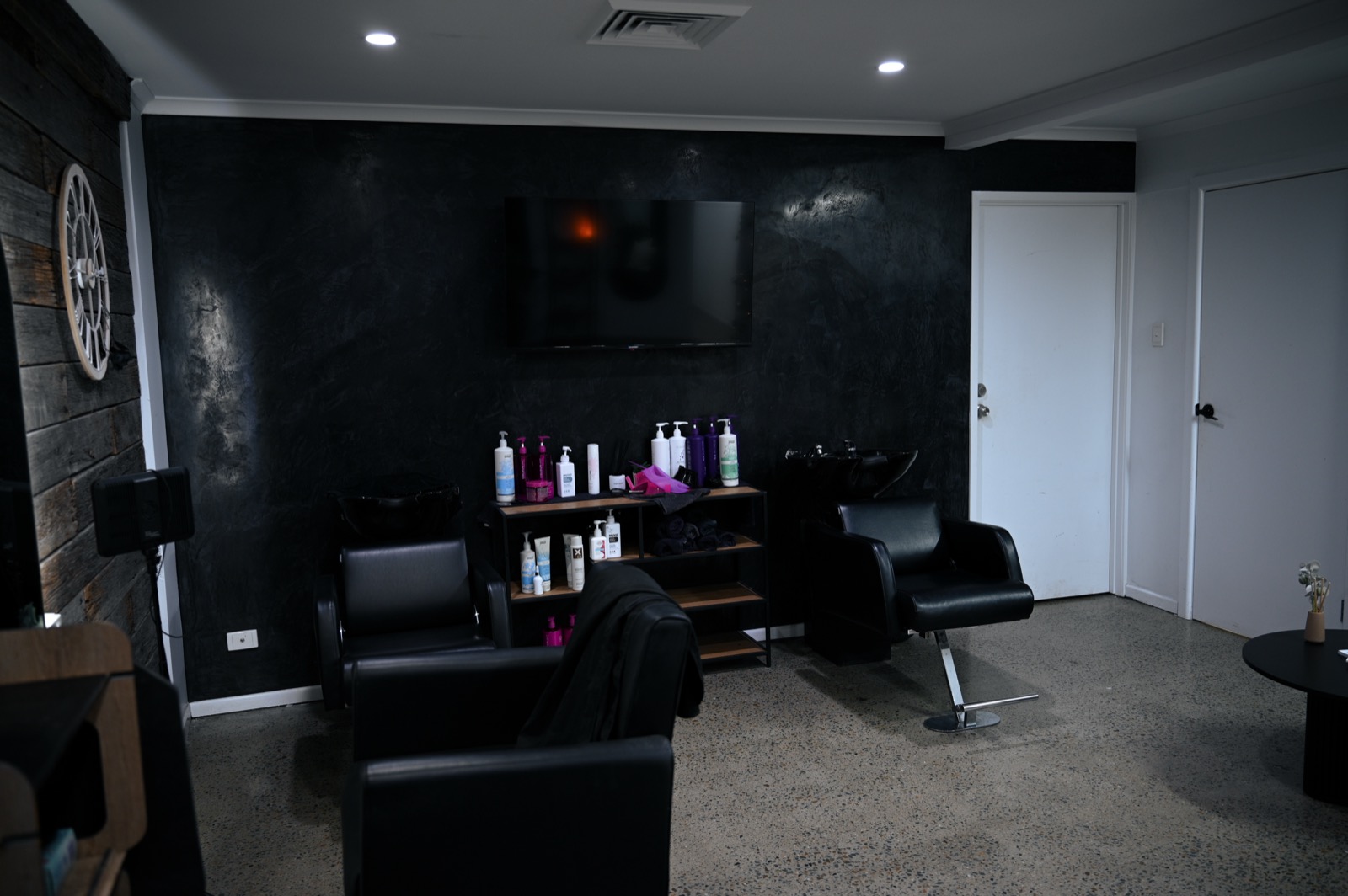 The Blackrose Salon — dark styling floor, colour station and wash basin